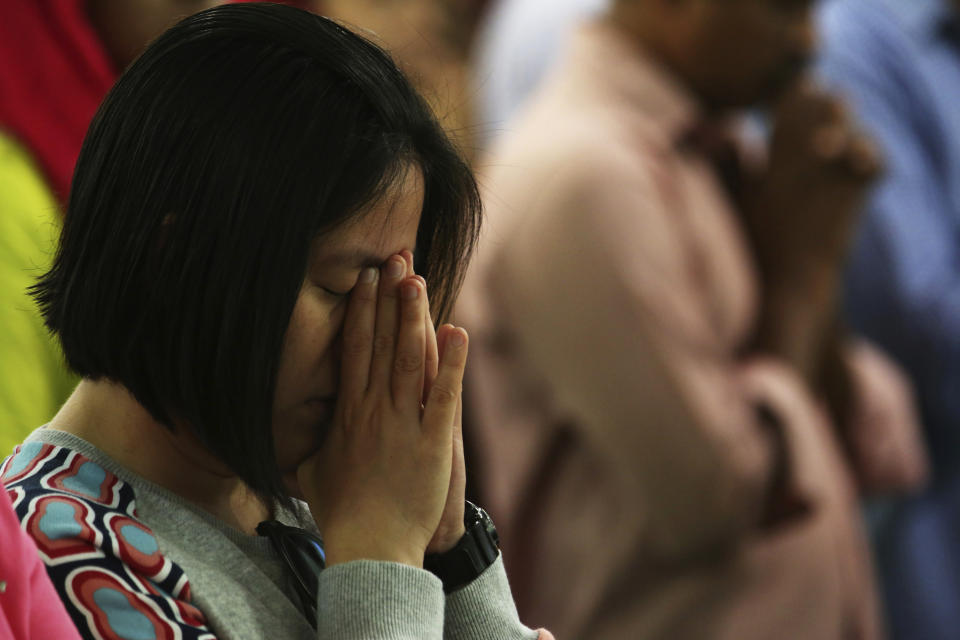 In this Sunday, Jan. 20, 2019 photo, a woman prays during Mass at St. Mary's Catholic Church in Dubai, United Arab Emirates. The Catholic Church's parishioners in the UAE come from around the world and will offer an international welcome to Pope Francis during his visit from Feb. 3 through Feb. 5, that marks the first ever papal visit to the Arabian Peninsula, the birthplace of Islam. The Catholic Church believes there are some 1 million Catholics in the UAE today. (AP Photo/Jon Gambrell)