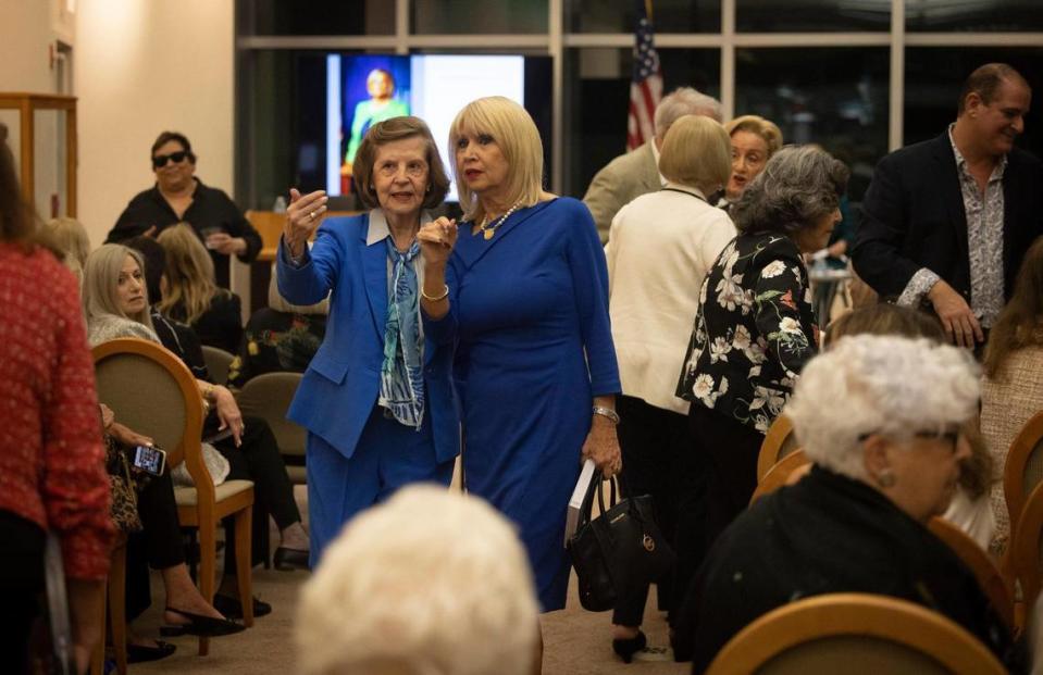 Arnhilda Badía, author of the book and former Professor at Florida International University, left, speaks with Mari Tere Rojas, chair of the Miami-Dade School Board, before a panel discussion about Badía’s book “Cuban American Women: Making History” with women featured in the book on Thursday, Jan. 25, 2024, at Otto G. Richter Library at the University of Miami in Coral Gables.