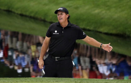 Phil Mickelson reacts after hitting onto the 16th green. (AP)