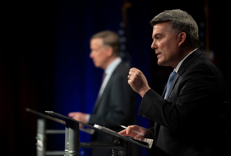 Republican U.S. Sen. Cory Gardner, right, participates with Democratic challenger and former Colorado Gov. John Hickenlooper in the final debate in the 2020 race for Colorado's U.S. Senate seat at Colorado State University in Fort Collins, Colo. on Tuesday, Oct. 13, 2020.