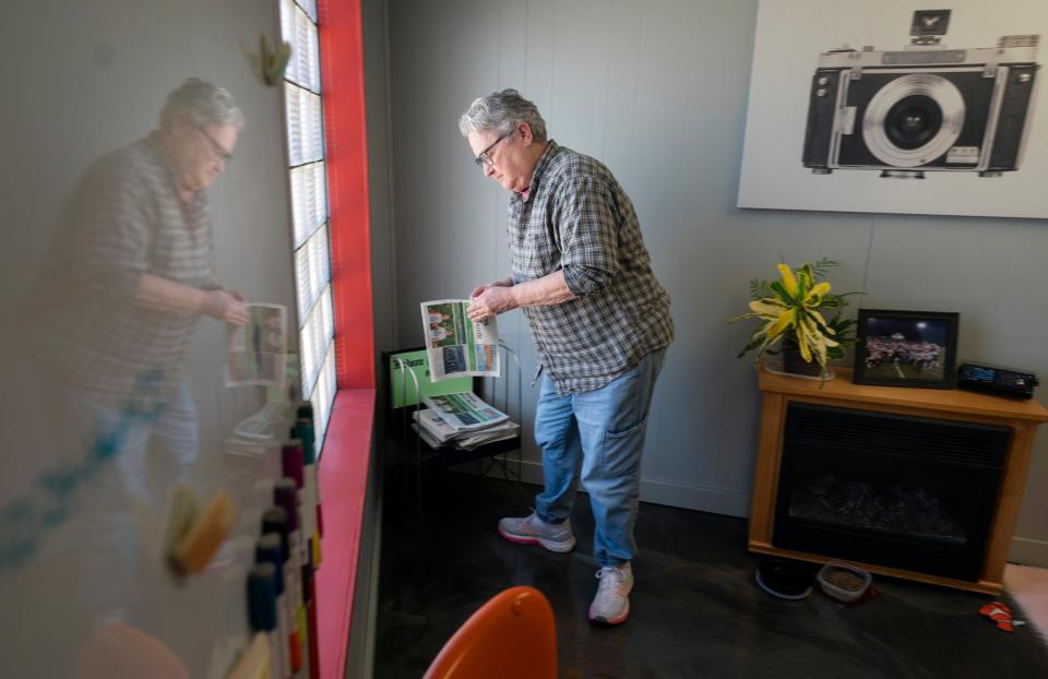 Barbara Ireland, 72, of Hudson, looks through a recent edition of the Hudson Post-Gazette on Monday, July 1, 2024, inside the newspaper's office.