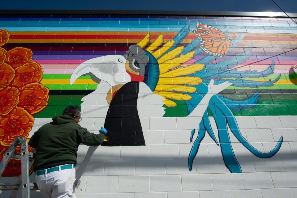 Artist Jaime Colón uses vibrant colors and stark contrasts in his section of mural.