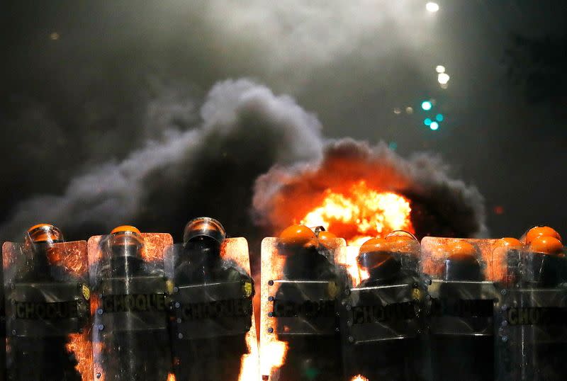 Riot police stand in formation during a protest against racism, after Joao Alberto Silveira Freitas was beaten to death by security guards at a Carrefour supermarket in Porto Alegre