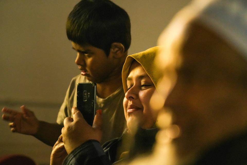 Golden light hits Abdul Wahab, 4, left, and his mother Noraidah Muhidden as they view Sesame Street in the Rohingya language with 6-year-old Rohingya twin characters named Aziz and Noor Saturday, Oct. 15, 2022, at the Burmese Rohingya Community of Wisconsin in Milwaukee.