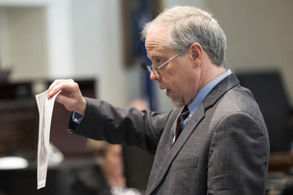 Prosecutor Creighton Waters holds up a falsified composite sketch Alex Murdaugh helped make during closing arguments.