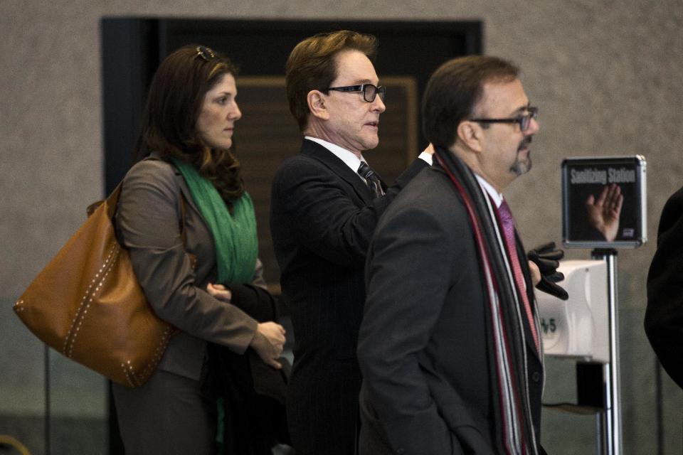 H. Ty Warner, center, the billionaire who created Beanie Babies, arrives at federal court for sentencing on Tuesday, Jan. 14, 2014, in Chicago. Last year Warner pleaded guilty to one count of tax evasion for hiding $25 million in income in secret Swiss bank accounts. (AP Photo/Andrew A. Nelles)