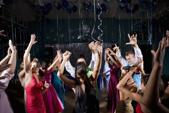 A bunch of teenagers dancing at prom.