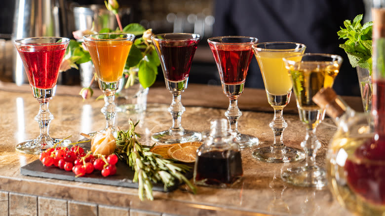 various glasses of colorful liqueurs