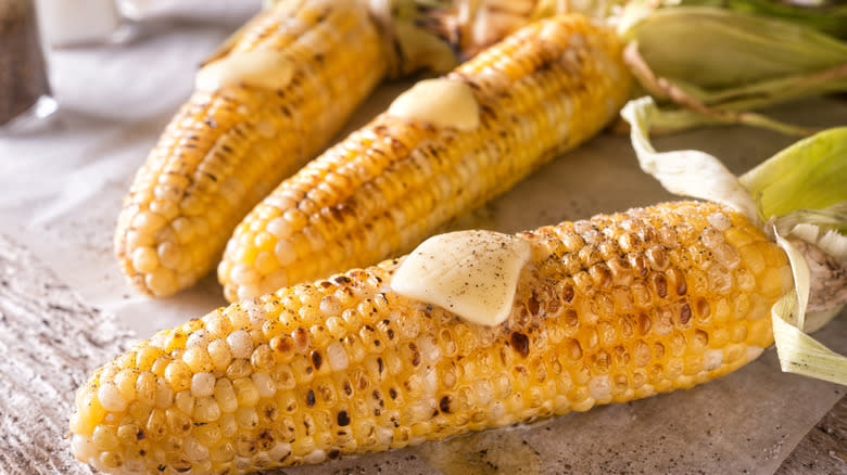 Charred ears of corn with butter