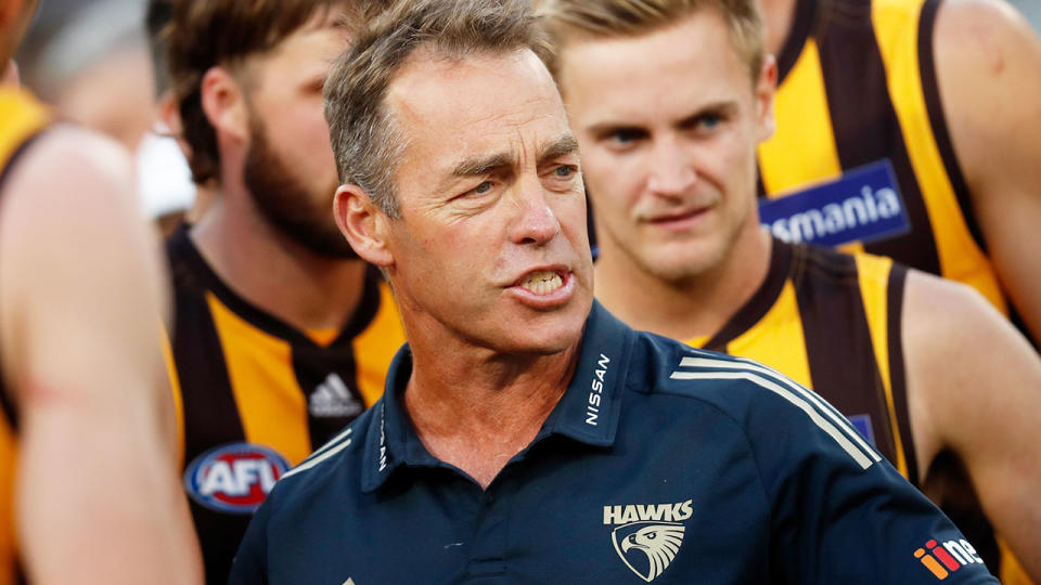 Pictured here, Alastair Clarkson speaks to his Hawthorn players during an AFL game.