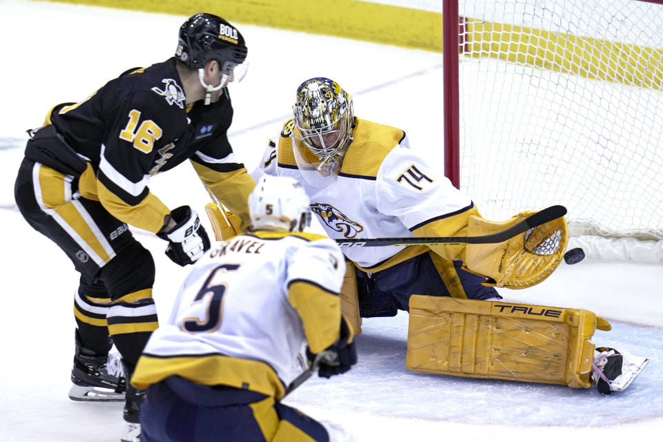 Pittsburgh Penguins' Jason Zucker (16) has a shot blocked by Nashville Predators goaltender Juuse Saros (74) during the first period of an NHL hockey game in Pittsburgh, Thursday, March 30, 2023. (AP Photo/Gene J. Puskar)