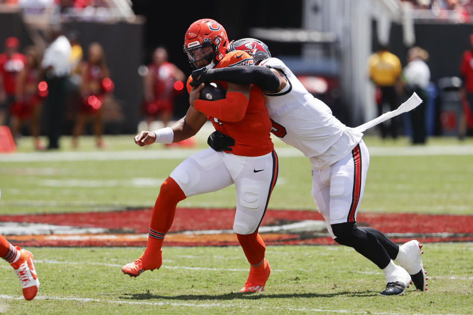 CORRECTS TO JOE TRYON-SHOYINKA NOT SIRVOCEA DENNIS Chicago Bears quarterback Justin Fields is tackled by Tampa Bay Buccaneers linebacker Joe Tryon-Shoyinka during the first half of an NFL football game, Sunday, Sept. 17, 2023, in Tampa, Fla. (AP Photo/Scott Audette)