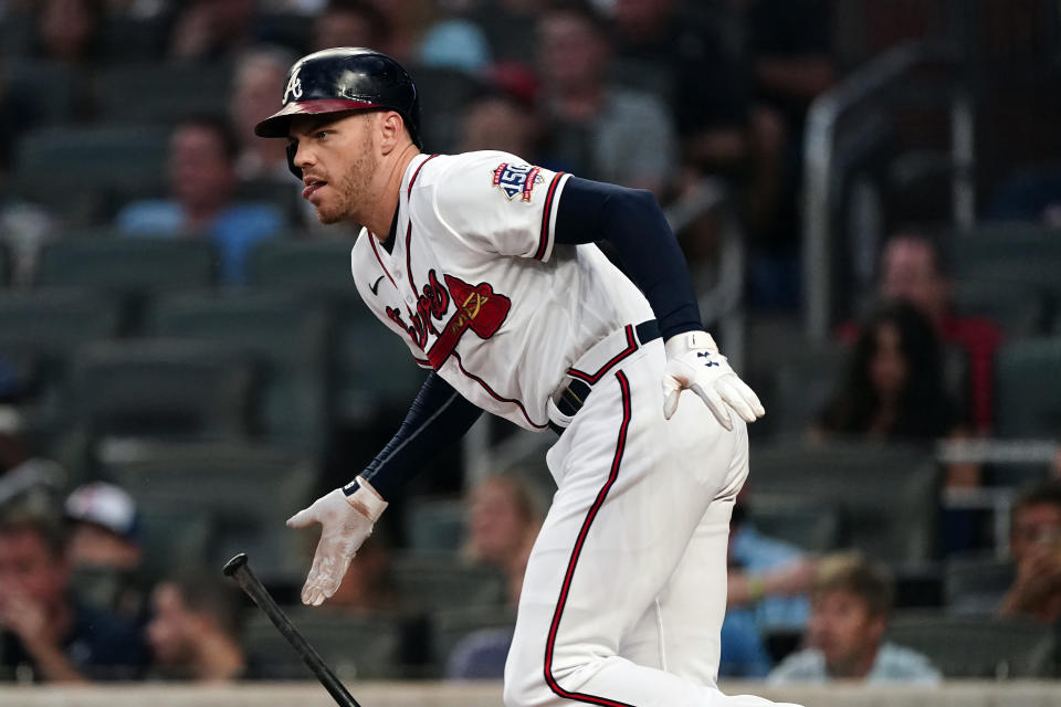 Atlanta Braves first baseman Freddie Freeman (5) drives in a run with a base hit in the first inning of a baseball game against the Colorado Rockies Tuesday, Sept. 14, 2021, in Atlanta. (AP Photo/John Bazemore)