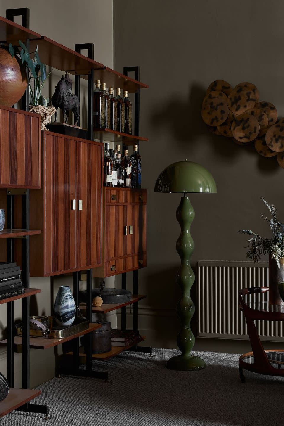 a room with a shelf and bookshelves