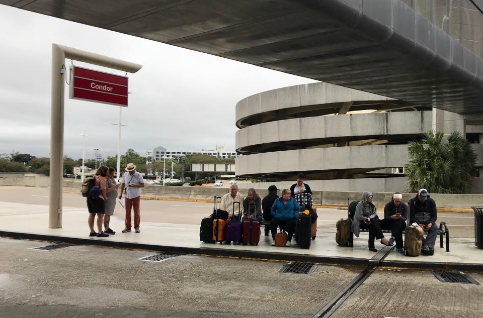 Crowds form at Louis Armstrong New Orleans International Airport after the remnants of Tropical Storm Olga knocked power out at the terminal early Saturday, Oct. 26, 2019. (David Grunfeld/The Times-Picayune/The New Orleans Advocate via AP)