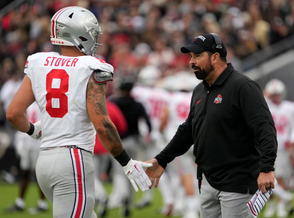 Oct. 14, 2023; Lafayette, In., USA; 
Ohio State Buckeyes head coach Ryan Day congratulates Ohio State Buckeyes tight end Cade Stover (8) coming off the field during the first half of Saturday's NCAA Division I football game against the Purdue Boilermakers at Ross-Ade Stadium in Lafayette.