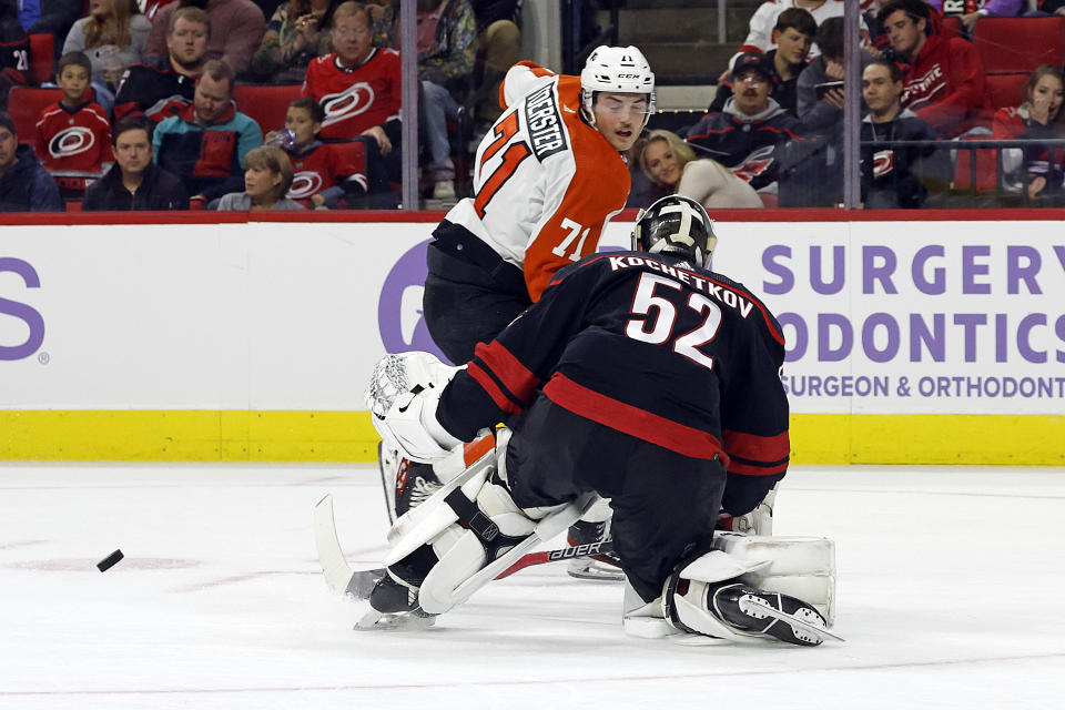 Carolina Hurricanes goaltender Pyotr Kochetkov (52) leaves the net to challenge Philadelphia Flyers' Tyson Foerster (71) during the first period of an NHL hockey game in Raleigh, N.C., Wednesday, Nov. 15, 2023. (AP Photo/Karl B DeBlaker)