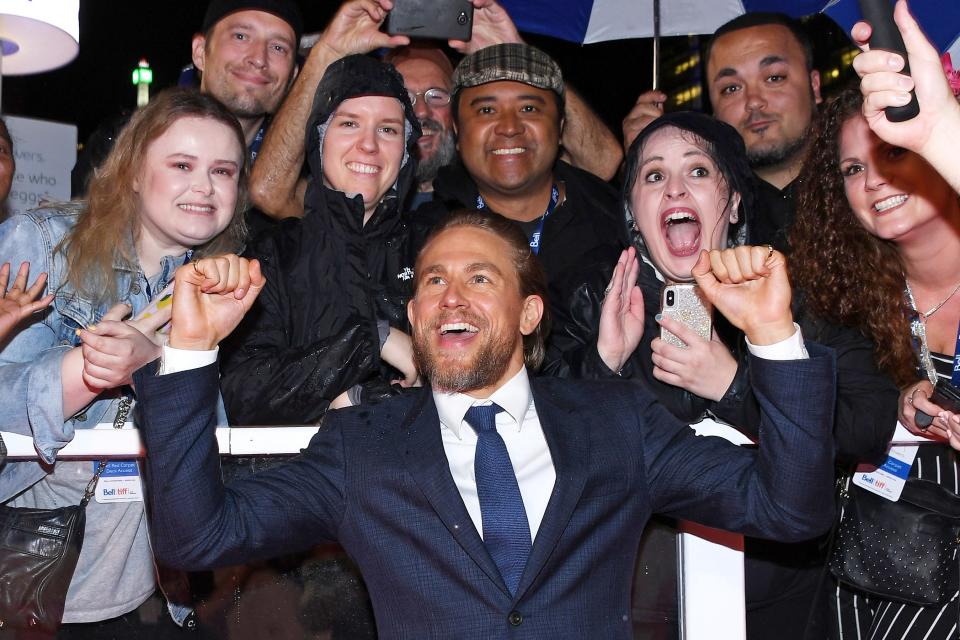 Charlie Hunnam cheers with fans as he walks the red carpet at the <em>True History of the Kelly Gang</em> premiere during the Toronto International Film Festival on Wednesday.