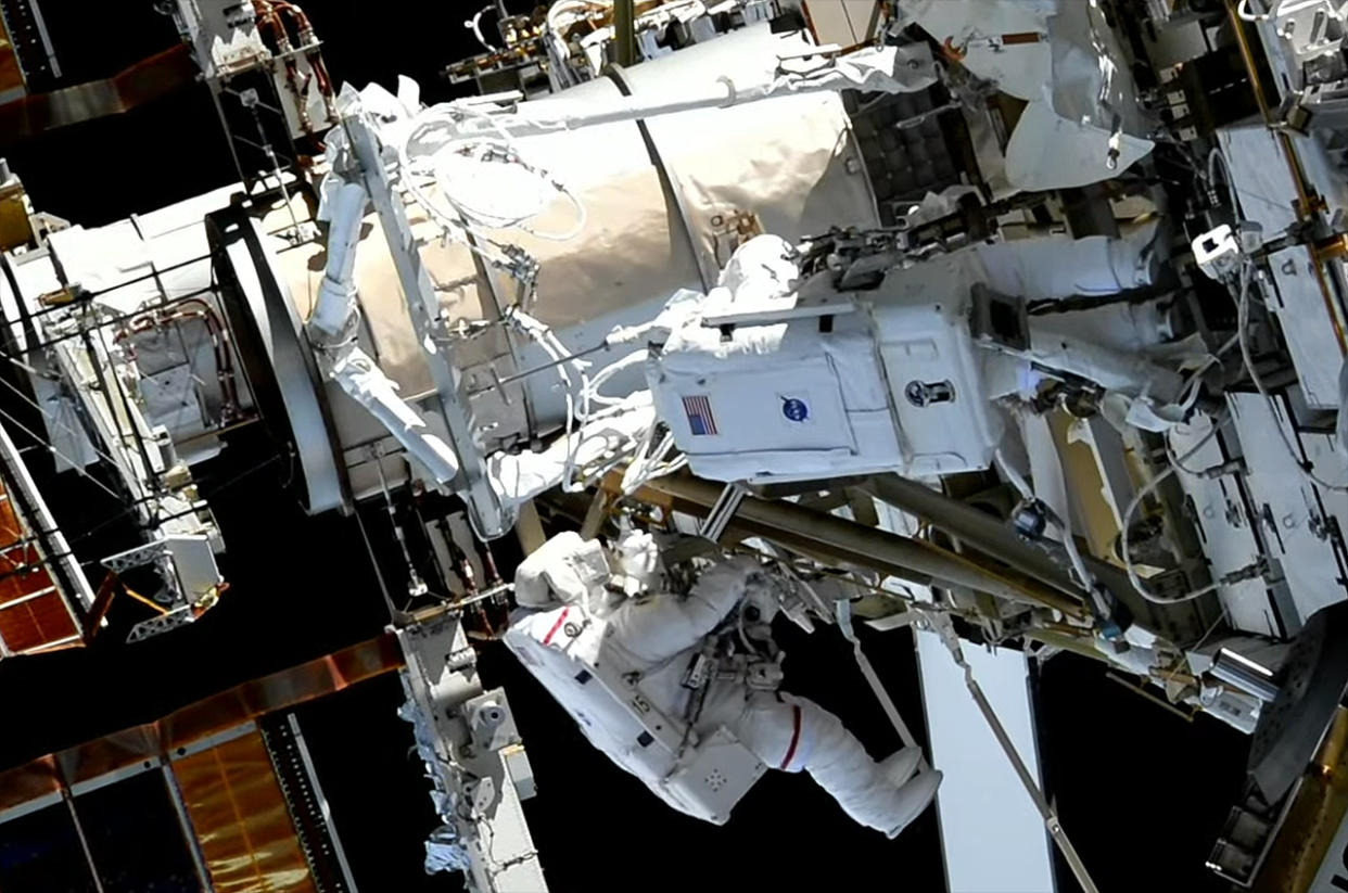  Astronauts Koichi Wakata of the Japan Aerospace Exploration Agency (at left) and Nicole Mann of NASA are seen near the new roll-out solar array mount they partially assembled during a spacewalk outside of the International Space Station on Friday, Jan. 20, 2023. 