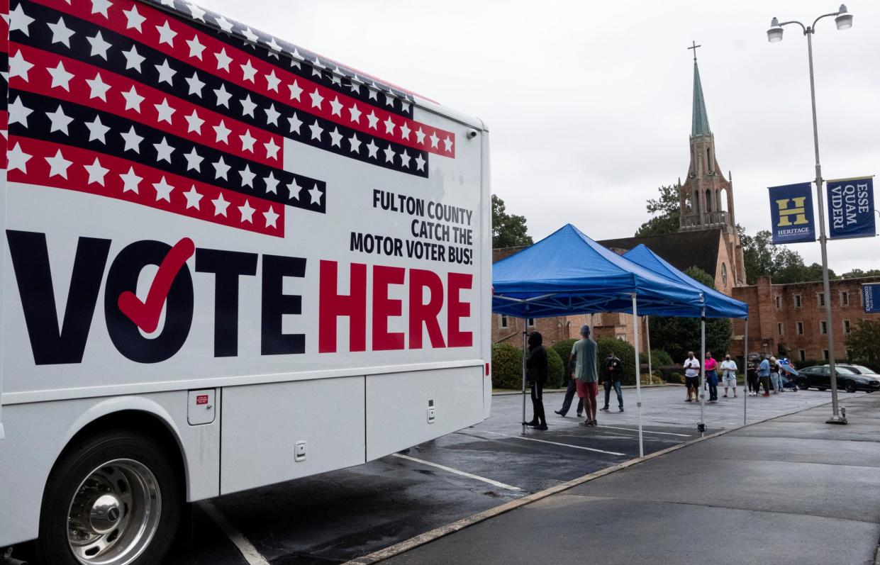 One of Fulton County's two mobile voting stations sits in the parking lot of Morningside Baptist Church on Monday morning, Oct. 12, 2020 for the first day of early voting. Election officials are increasingly worried about voter intimidation on Election Day. (Ben Gray/Atlanta Journal-Constitution via AP)