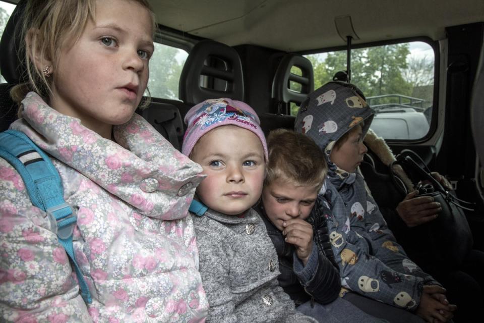 Four of Valentyna’s children - Tetiana, 10, Angelina, 6, Iaroslav, 8, and Sasha, 9 - are pictured in the back of a minibus as they drive towards Kharkiv from the hometown of Zakharivka (Anadolu/Getty)