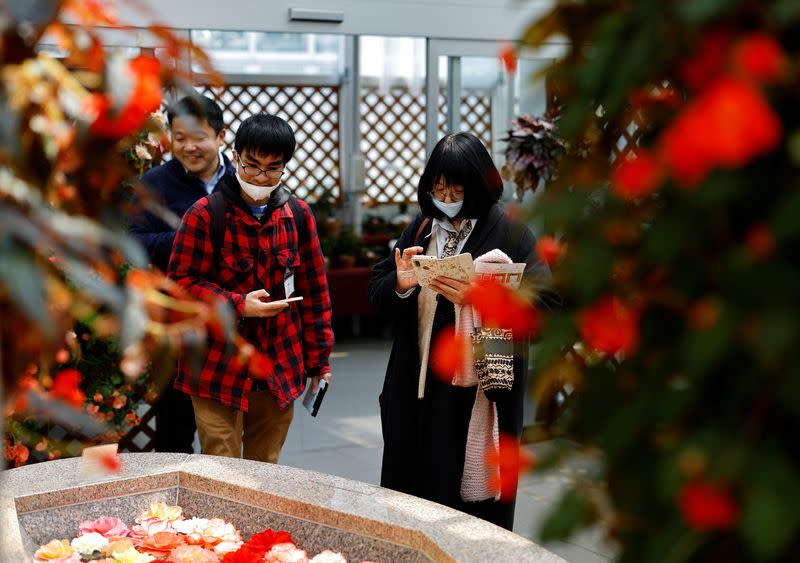 Participants take part in a matchmaking event using mystery solving game, which is organized by Tokyo metropolitan government at Jindai Botanical Gardens in Tokyo