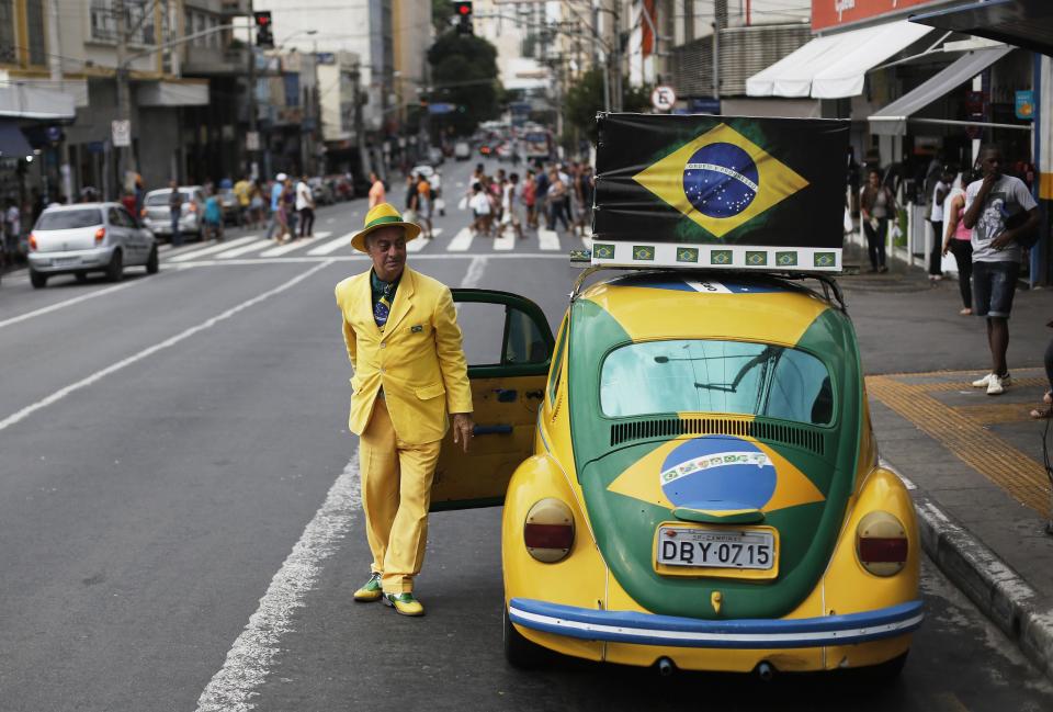 Brazilian attorney, Nelson Paviotti, parks one of his two Volkswagen Beetles painted with the colors of the national flag in Campinas