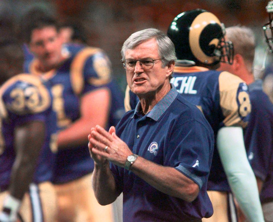 St. Louis Rams coach Dick Vermeil talks to his players before a preseason game against the San Diego Chargers in St. Louis, Aug. 28, 1999.