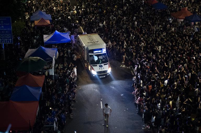 Pro-democracy demonstrators let an ambulance go through as the protestors gather for the third night in Hong Kong on September 30, 2014