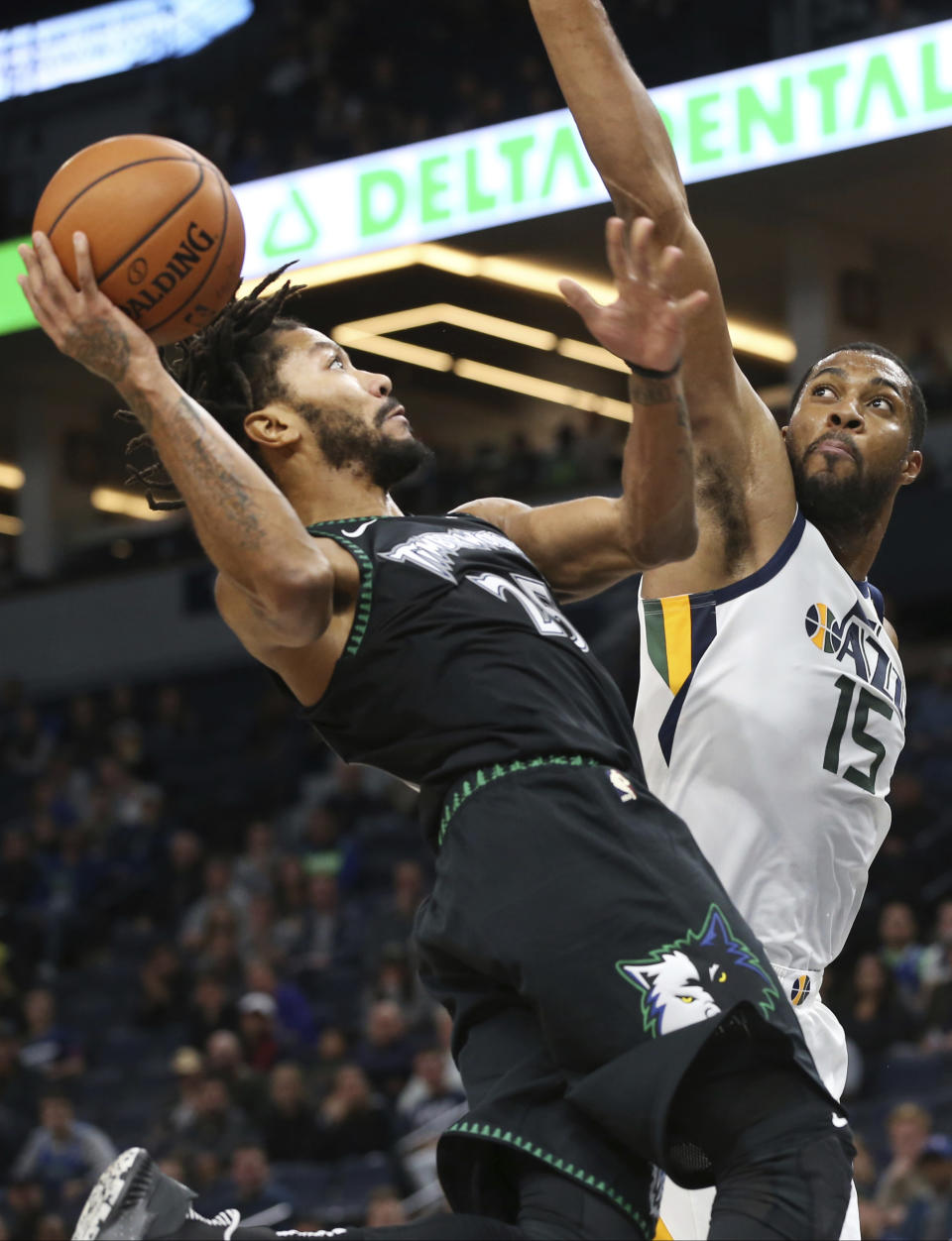 Minnesota Timberwolves' Derrick Rose, left, shoots as Utah Jazz's Derrick Favors defends during the second half of an NBA basketball game Wednesday, Oct. 31, 2018, in Minneapolis. The Timberwolves won 128-125. Rose scored a career-high 50 points. (AP Photo/Jim Mone)