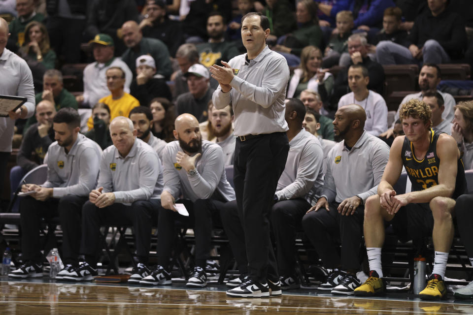 Baylor head coach Scott Drew, center, talks to his team on the floor during the first half of an NCAA college basketball game against Gonzaga, Friday, Dec. 2, 2022, in Sioux Falls, S.D. (AP Photo/Josh Jurgens)