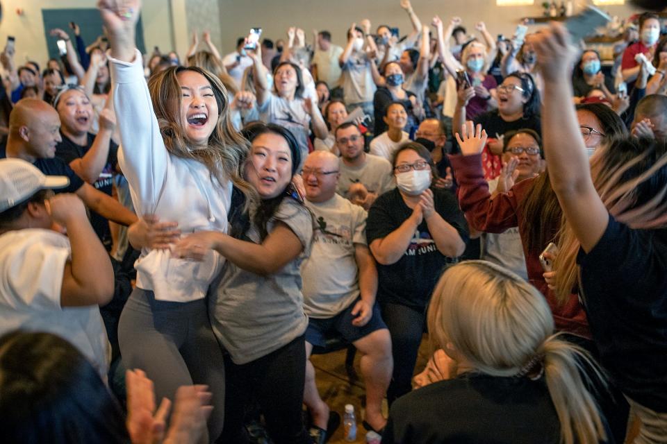 July 29, 2021: Shyenne Lee, 18, left foreground, the older sister of St. Paul Olympian Sunisa Lee, reacts alongside Souayee Vang and other family and friends as they watch Sunisa Lee clinch the gold medal in the women's Olympic gymnastics all-around at the Tokyo Olympics in Oakdale, Minn. 