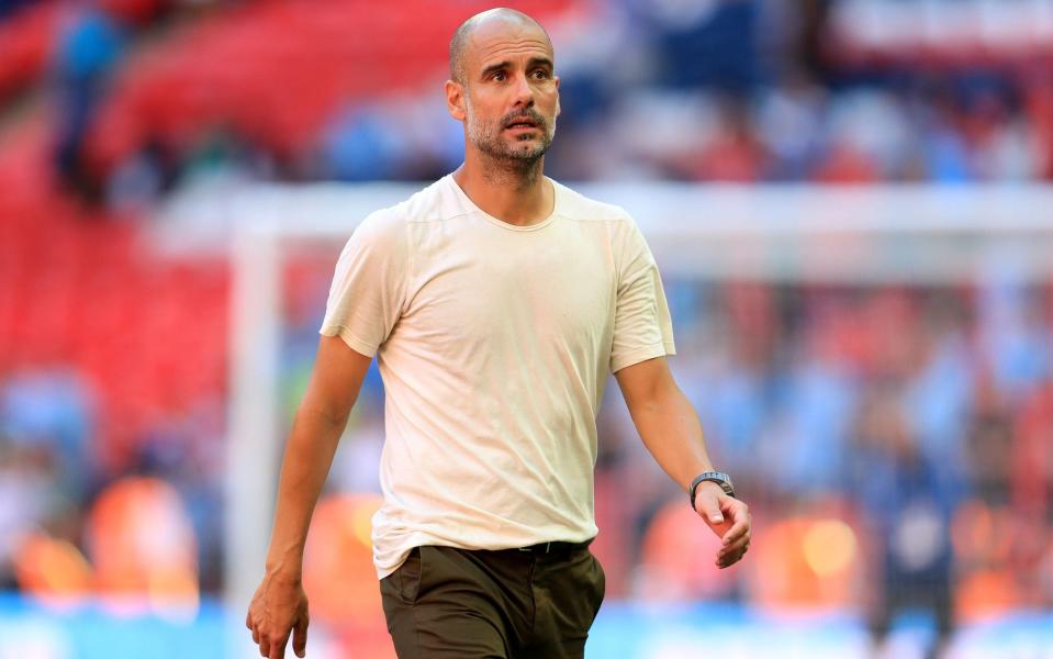 Pep Guardiola in t-shirt and chinos - PA