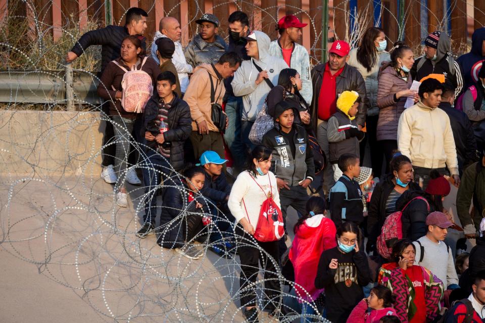 Migrants crossed the Rio Grande and approach the Texas National Guard to enquire when they will be allowed to be processed by Customs and Border Protection to seek asylum in El Paso, Texas on Dec. 20, 2022.