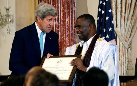 U.S. Secretary of State John Kerry presents an award to Biram Abeid of Mauritania during the Trafficking in Persons (TIP) Heroes Ceremony at the State Department in Washington, June 30, 2016. REUTERS/Kevin Lamarque