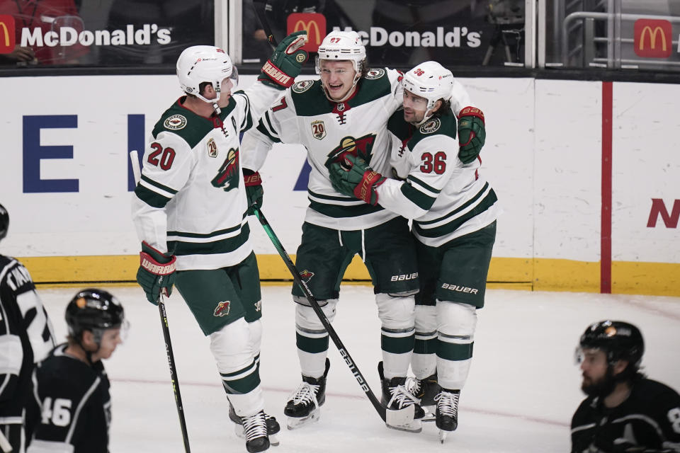 FILE - Minnesota Wild's Kirill Kaprizov, center, of Russia, celebrates his goal with Ryan Suter, left, and Mats Zuccarello, of Norway, during the first period of an NHL hockey game against the Los Angeles Kings in Los Angeles, in this Friday, April 23, 2021, file photo. One of five Wild players to skate in all 56 games, the 24-year-old Kaprizov finished the regular season with 27 goals and 51 points to lead all NHL rookies in both categories. (AP Photo/Jae C. Hong, File)