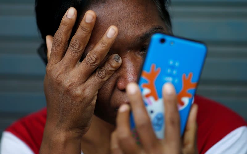 Victim's family member cries in front of the Terminal 21 shopping mall following a gun battle involving a Thai soldier on a shooting rampage, in Nakhon Ratchasima