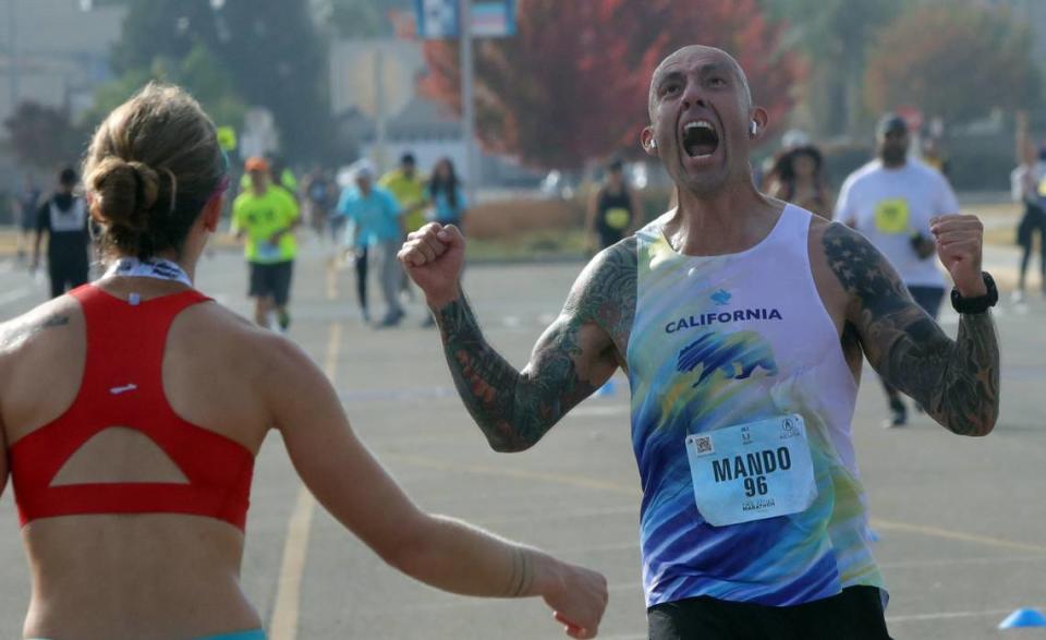 Armando Arias, 43, of Visalia, reacts after breaking the 3-hour mark at the Two Cities Half Marathon on Nov. 5, 2023.