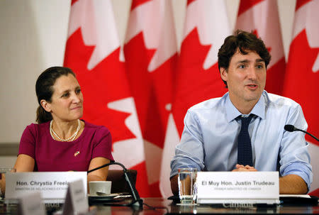 FILE PHOTO: Canadian Prime Minister Justin Trudeau addresses participants in a roundtable discussion with civil society leaders, next to Canada's Foreign Minister Chrystia Freeland, in Mexico City, Mexico, October 12, 2017. REUTERS/Carlos Jasso/File Photo