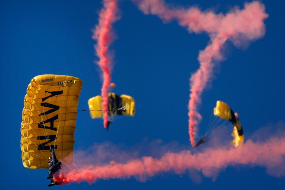 Members of the Navy Leap Frogs parachute team drop in before the NCAA college football game between Army and Navy in Philadelphia, Saturday, Dec. 12, 2009.