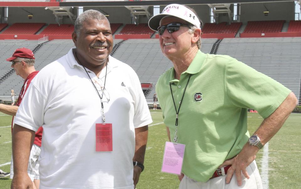 South Carolina head coach Steve Spurrier, right, and Houston Texans defensive coordinator Romeo Crennel talk after defensive end Jadeveon Clowney competed in a drill for NFL representatives at South Carolina football pro day in Columbia, S.C., Wednesday, April 2, 2014. (AP Photo/Mary Ann Chastain)