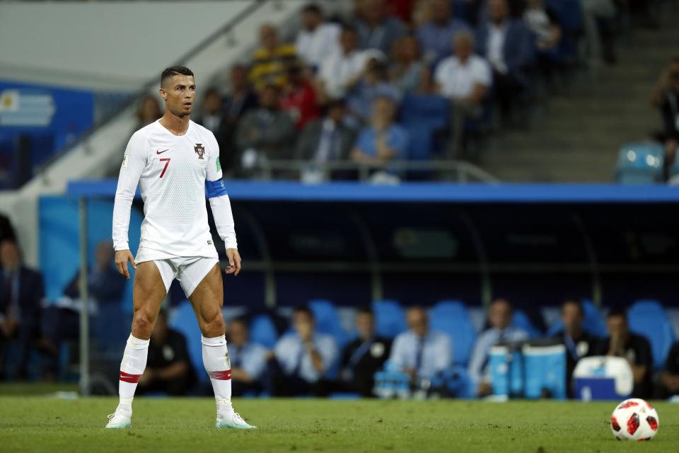 <p>The look-at-me moment as Cristiano Ronaldo prepares to take a first-half free-kick against Uruguay. This time it hit the defensive wall, rather than the net </p>