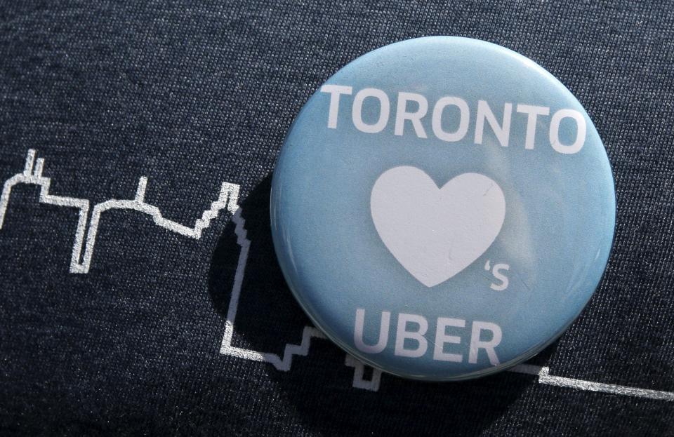 An Uber supporter's pin is seen during a rally in front of city hall in Toronto. REUTERS/Chris Helgren