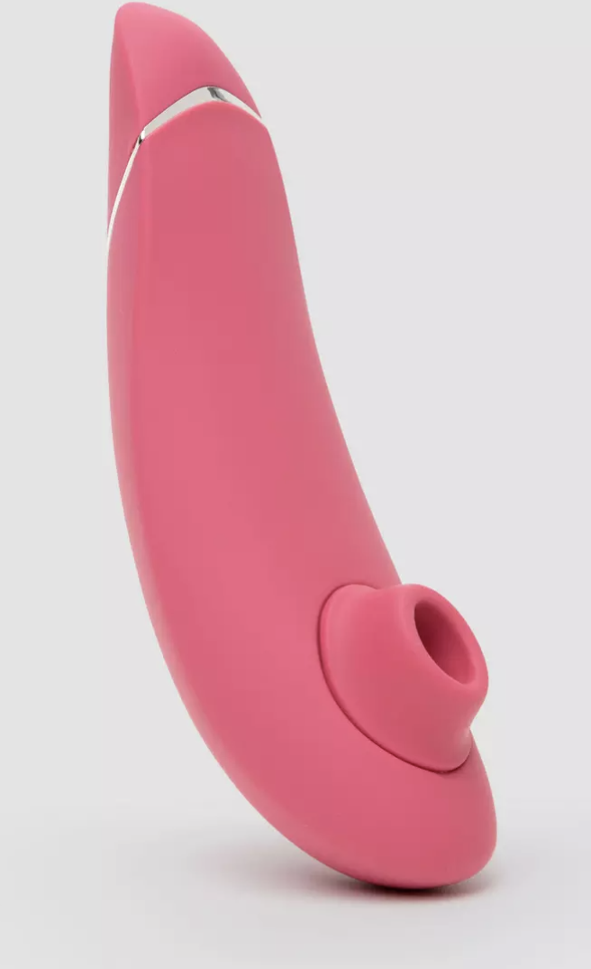 The Womanizer clitoral suction stimulator on a grey background