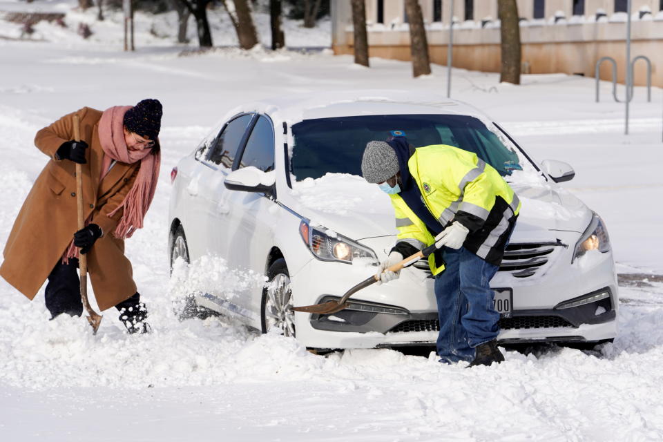  奧克拉荷馬州多處被白雪覆蓋，導致路上交通大亂，民眾合力剷雪試圖讓轎車脫困。圖片來源：Reuters。