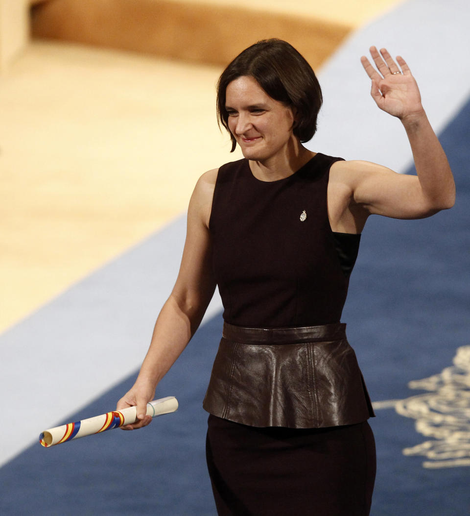 FILE - In this Friday Oct. 23, 2015 file photo, Esther Duflo of France waves after receiving the Princess of Asturias award for Social Sciences from Spain's King Felipe VI at a ceremony in Oviedo, northern Spain. The 2019 Nobel prize in economics has been awarded to Abhijit Banerjee, Esther Duflo and Michael Kremer "for their experimental approach to alleviating global poverty." The Royal Swedish Academy of Sciences announced the prize on Monday Oct. 14, 2019. (AP Photo/Jose Vicente, File)