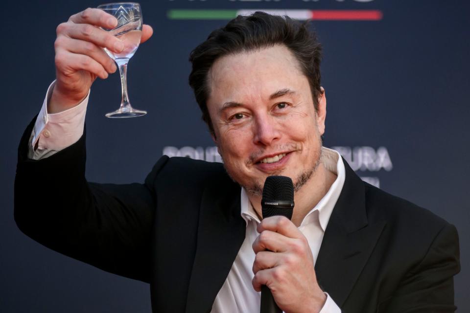 Elon Musk toasting with wine glass
