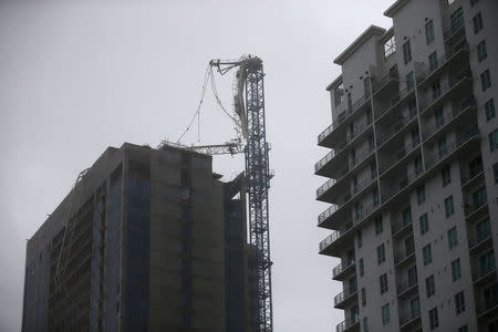 A collapsed construction crane is seen in Downtown Miami as Hurricane Irma arrives at south Florida, September 10, 2017. REUTERS/Carlos Barria