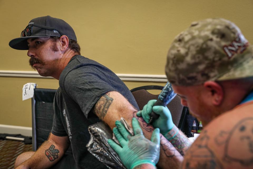 Texas tattoo artist Mike Wojo, of Fort Worth, tattoos a zombie style Bride of Frankenstein on Corpus Christi resident Coady Kenyon's arm during the Golden Wave Tattoo Convention at Emerald Beach Hotel in Corpus Christi, Texas, on Saturday, Sept. 10, 2022.