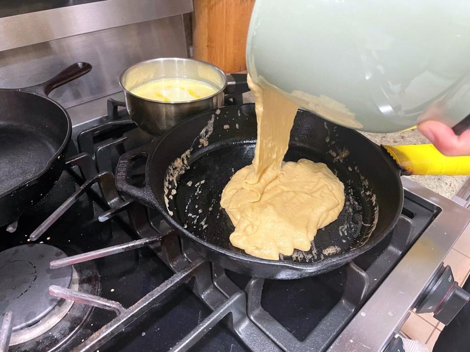 Adding batter to cast-iron skillet for Ina Garten cornbread